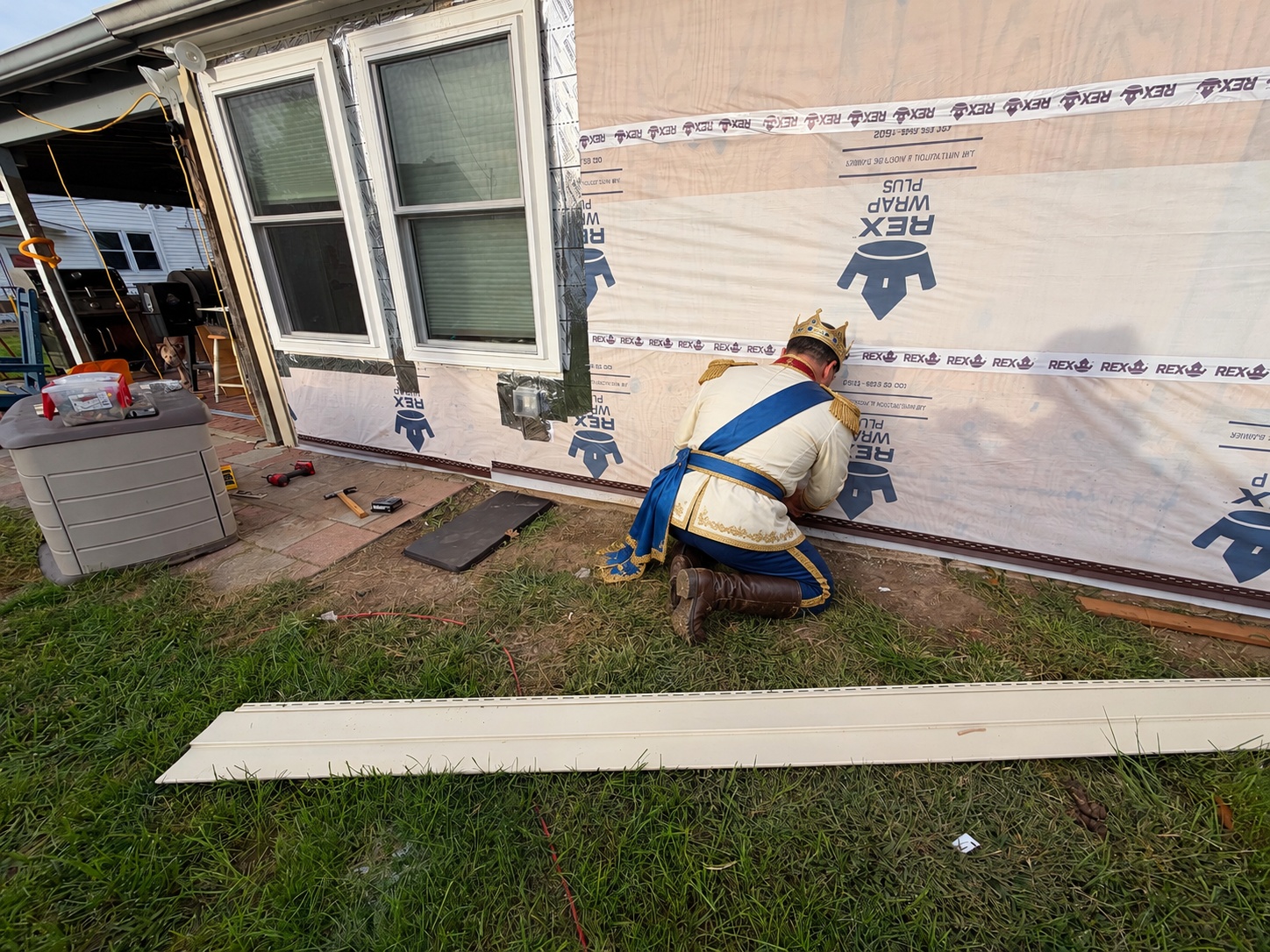 Prince Charming working on siding during the renovation